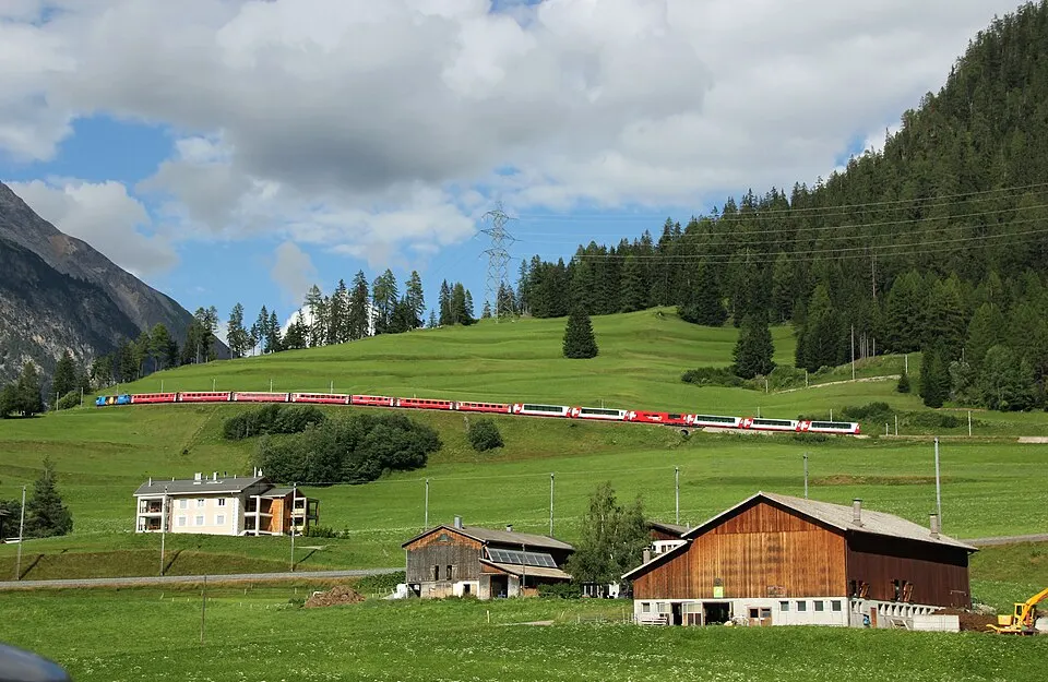 Albula line, RhB train with Glacier Express going uphill near Bergün (Bravougn)