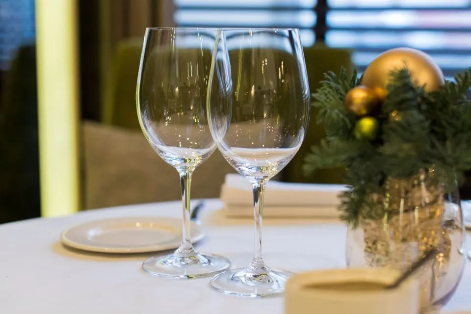 Apollo — Sophisticated dining table setup with wine glasses and festive Christmas decorations offering elegance and…