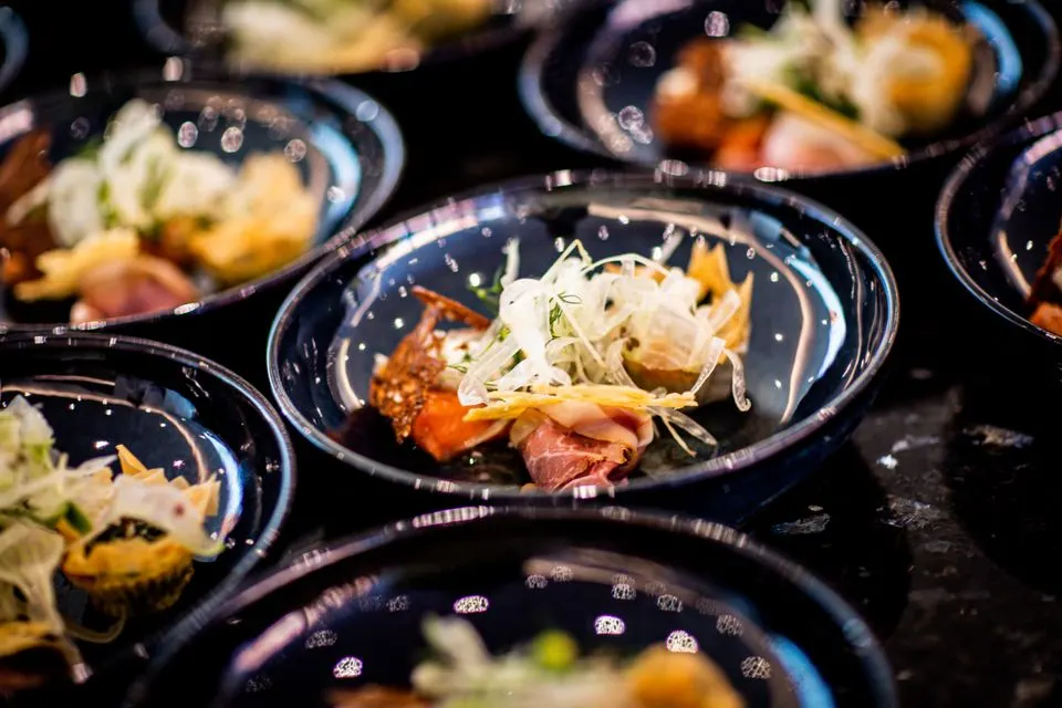 Centric Dining — A close-up of gourmet food on elegant plates, showcasing fresh ingredients and culinary artistry.