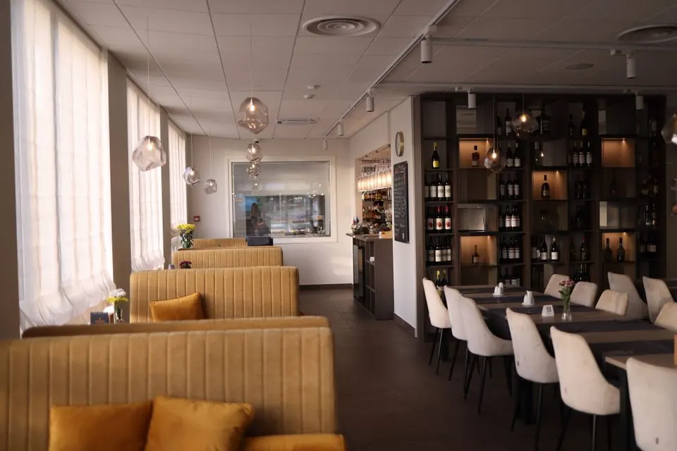 Corso — Modern restaurant interior design featuring cozy booth seating and elegant lighting.