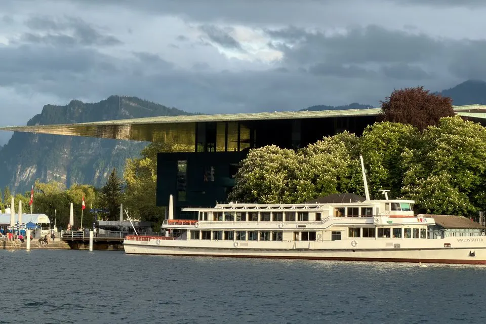 de Matos — Picturesque Lake Lucerne with a classic paddle steamer and modern architecture.