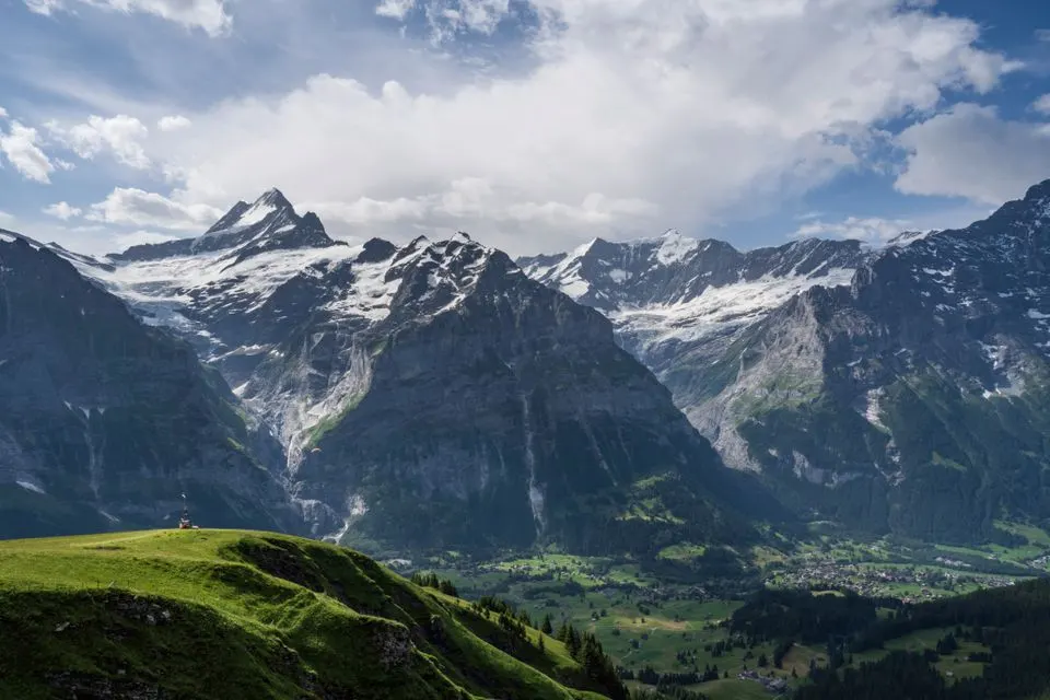 Fiescherblick — Panoramic view of the Swiss Alps in the Jungfrau region with lush green valleys and snow-capped peaks.