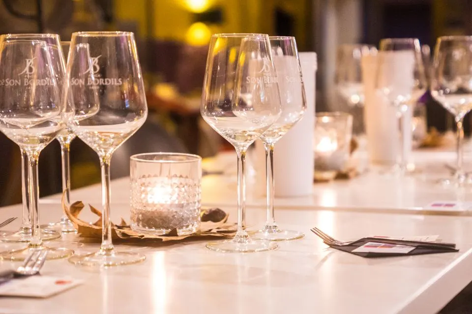 La Table de Valrose — Elegant dinner table setting with glasses and candlelight in a cozy setting in Palma, Spain.