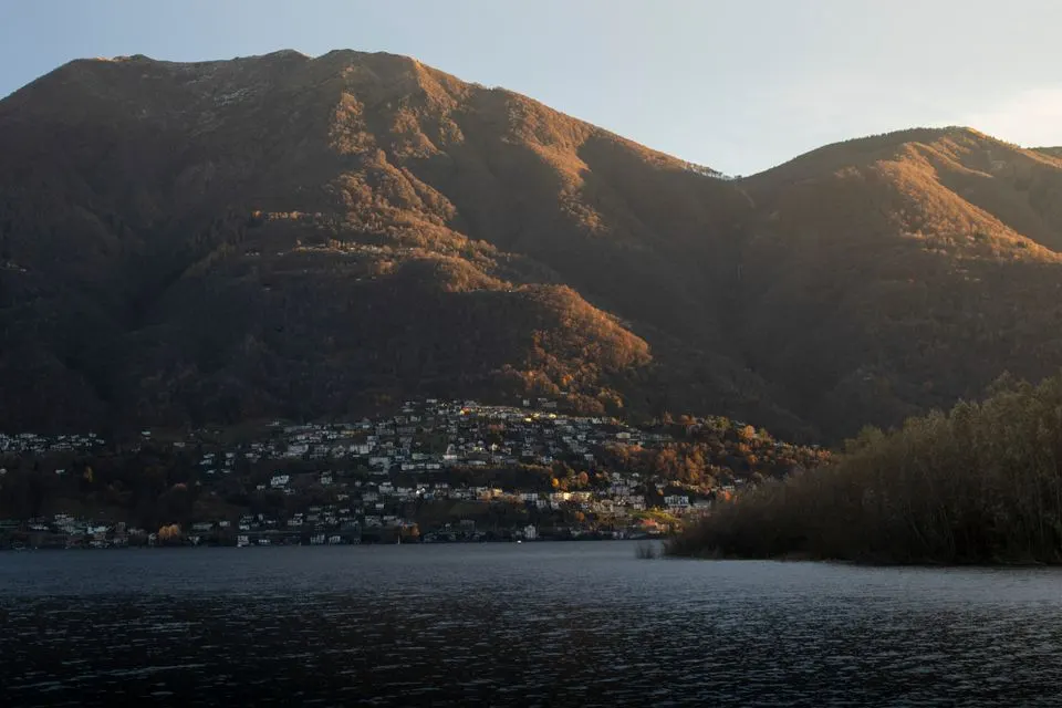 Locarno Film Festival — Captivating view of Locarno, Switzerland with hills and lake under warm sunset light.