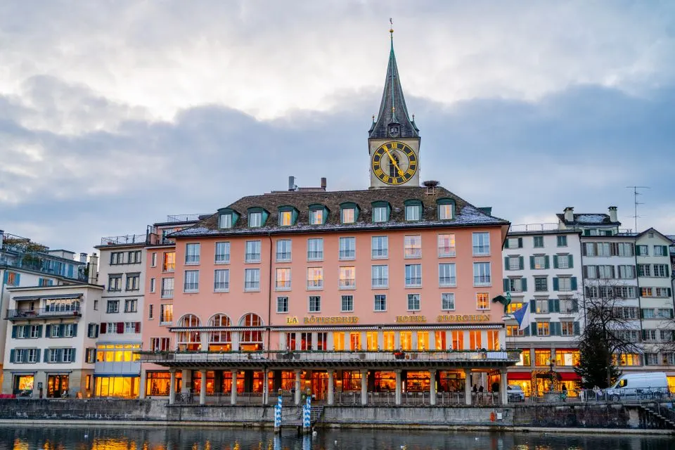 Mandarin Oriental Savoy, Zurich — Charming Zurich architecture on display during twilight along the waterfront.