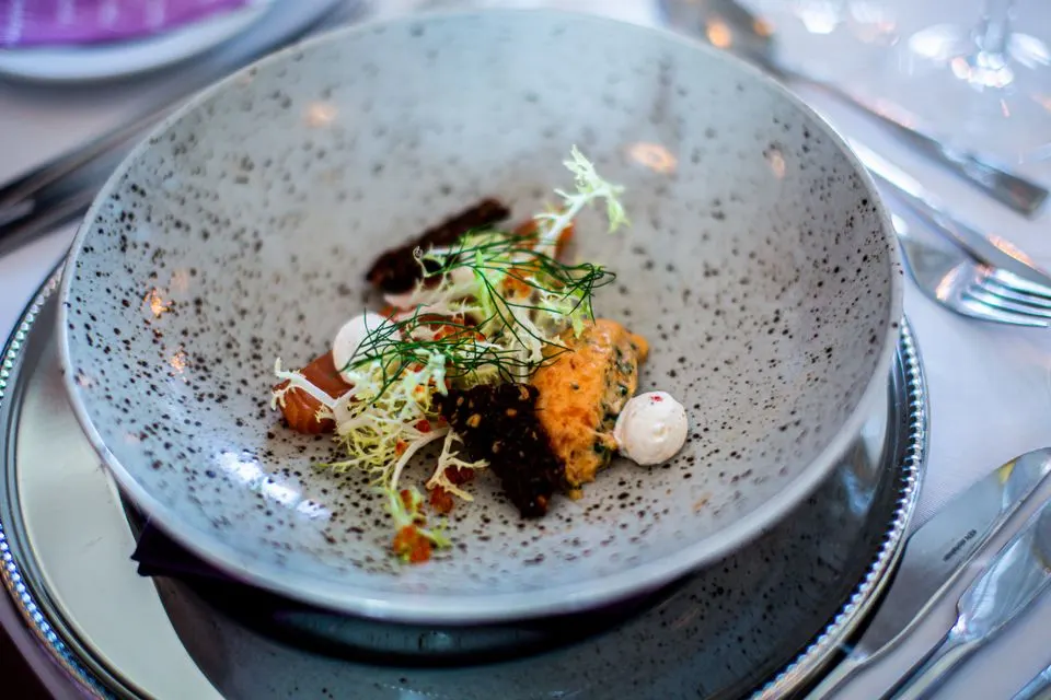 Memories — Close-up of a gourmet meal served on a stylish plate, featuring fresh herbs and delicate presentation.