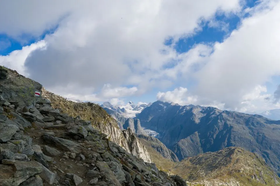No. 4 ViaJacobi — Stunning view of rocky alpine path in Swiss Alps with clear skies and majestic peaks.