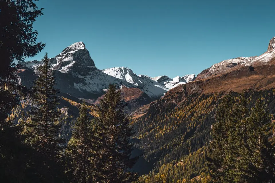 No. 6 Graubünden Route — Majestic view of snow-capped peaks in Graubünden, Switzerland during fall.